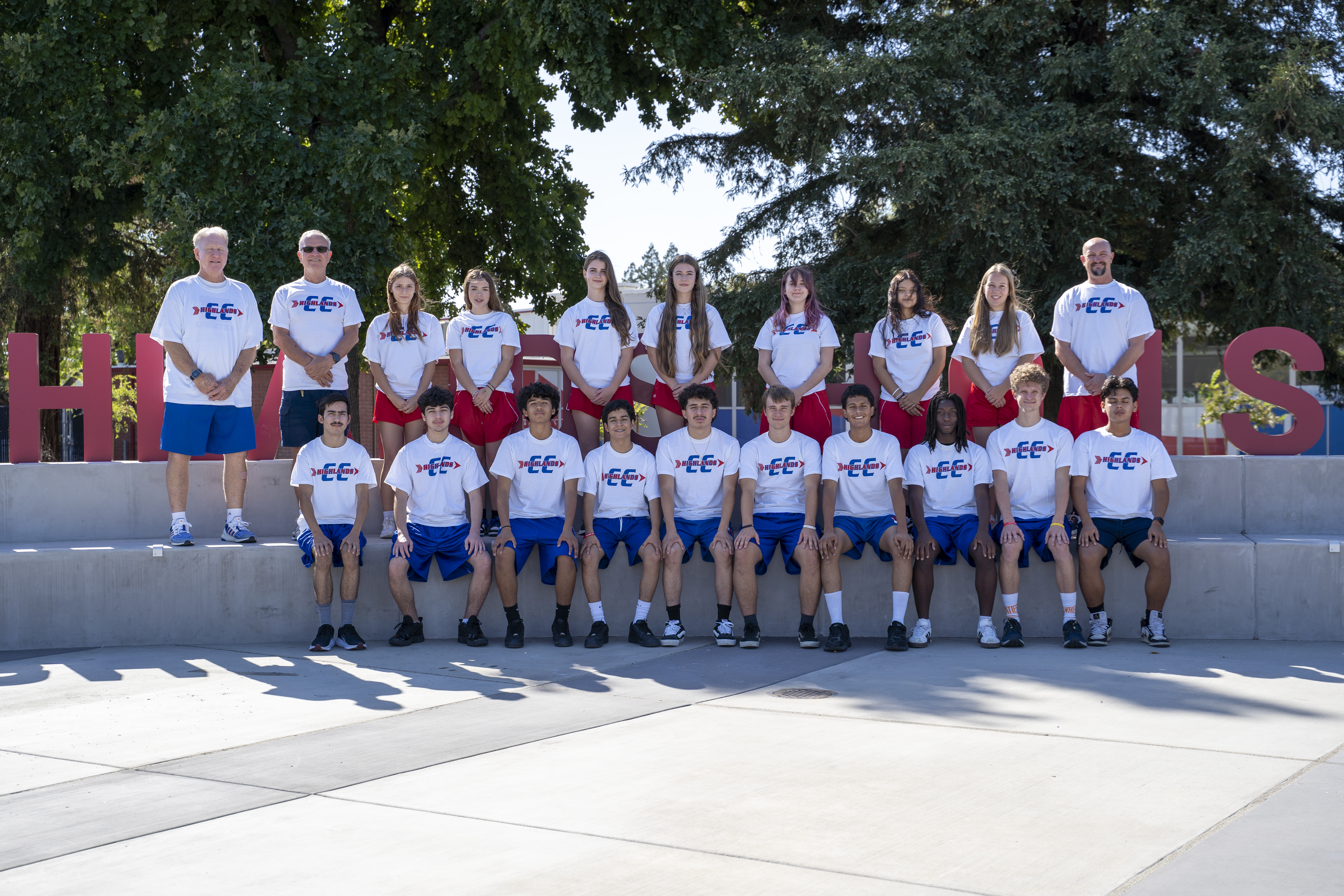 CROSS COUNTRY PHOTO IN FRONT OF SCHOOL SIGN